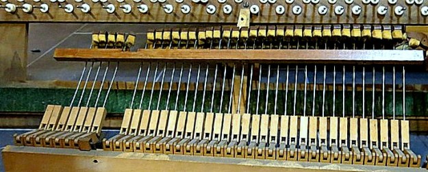 Plenty of reusable wood, wire and felt in the guts of this old piano.